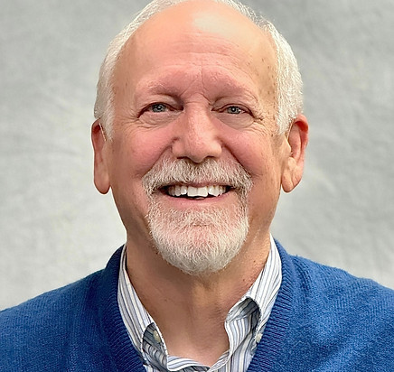 Dr. Kevin Downing smiling in a professional headshot.