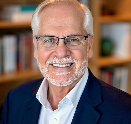 Dr. Peter Robbins smiling in a professional headshot.