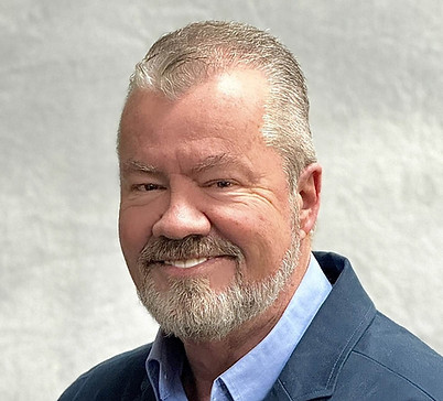 Greg Meeker smiling in a professional headshot.